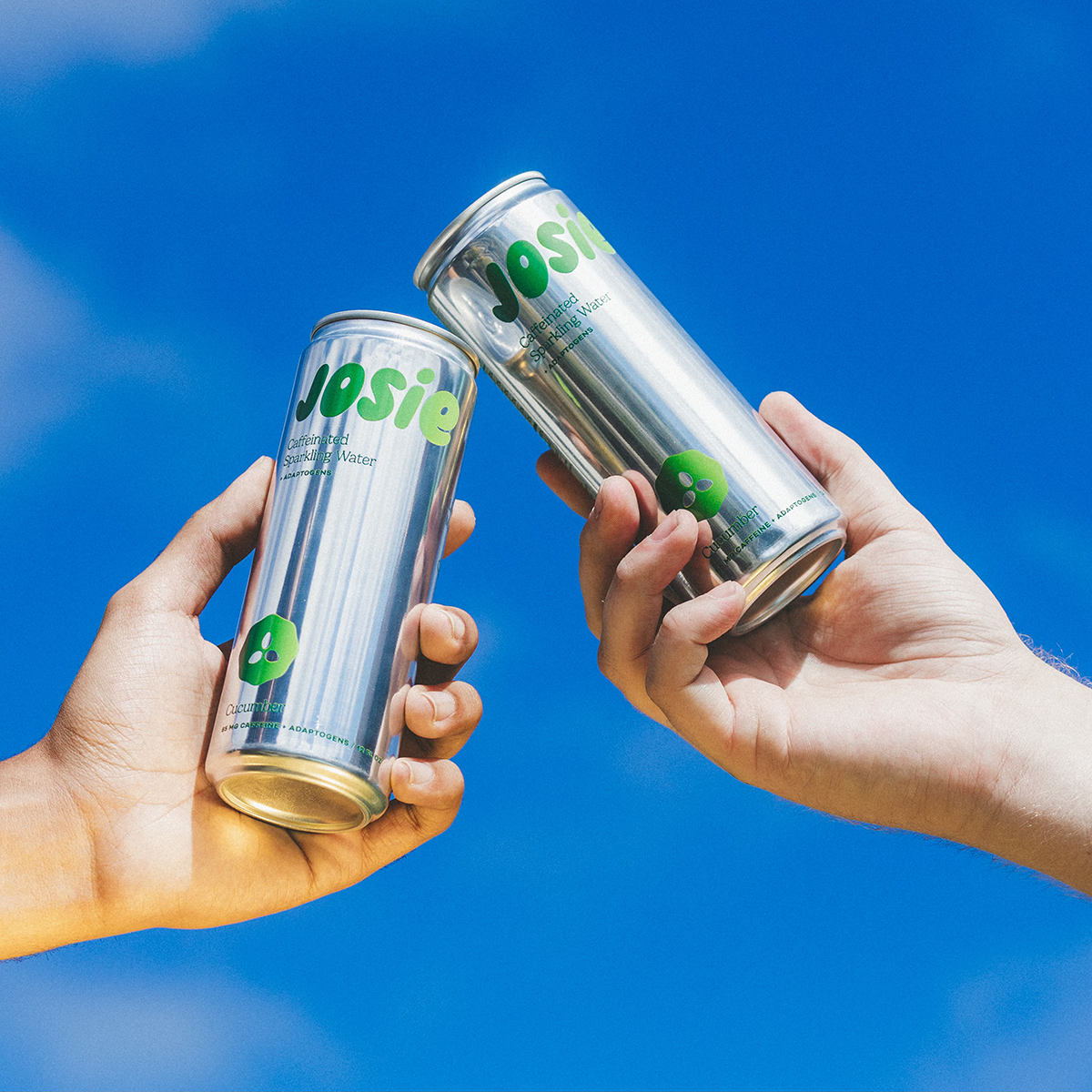 Two cans of Josie against a blue sky